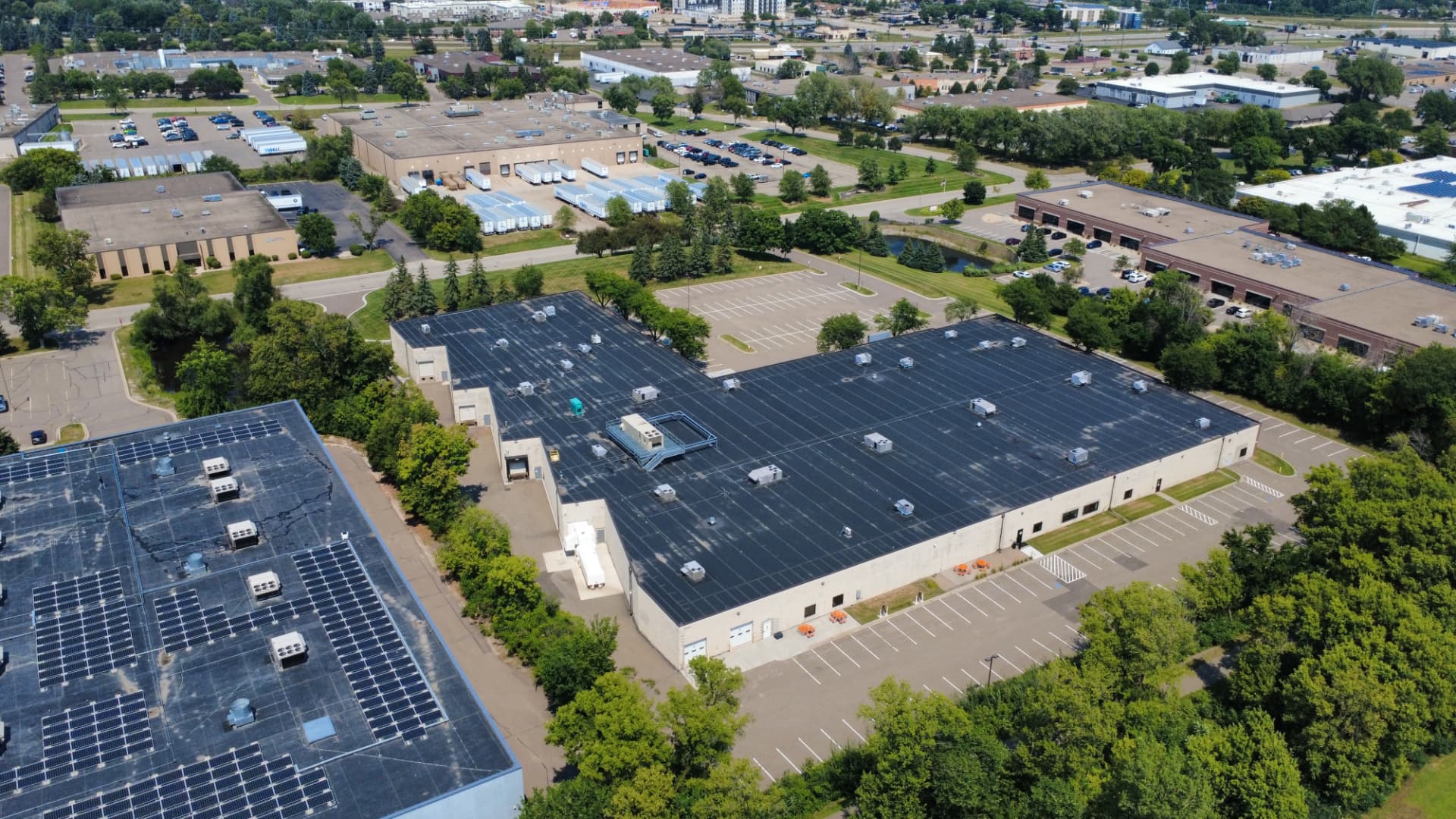 Aerial view of the building roofline and surrounding business park